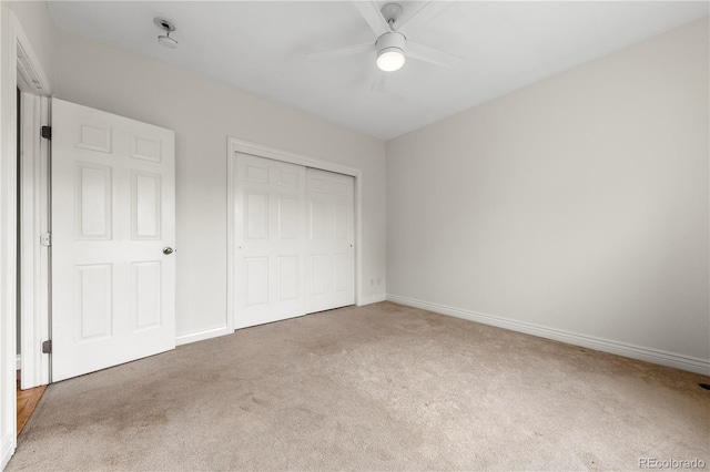 unfurnished bedroom featuring a closet, ceiling fan, baseboards, and carpet