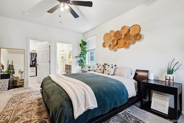 bedroom with ceiling fan, carpet, and connected bathroom