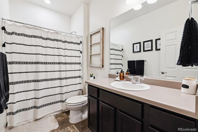 bathroom with a shower with shower curtain, vanity, and toilet