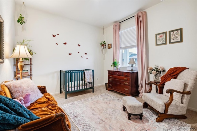 bedroom featuring baseboards and light colored carpet