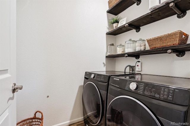 laundry room featuring laundry area, separate washer and dryer, and baseboards