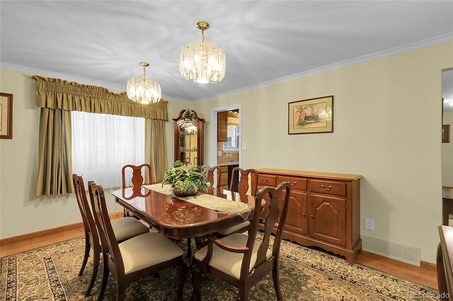 1091 E Pinewood Ave, Centennial, CO 80121 - dining space with a chandelier, light wood-type flooring, and ornamental molding
