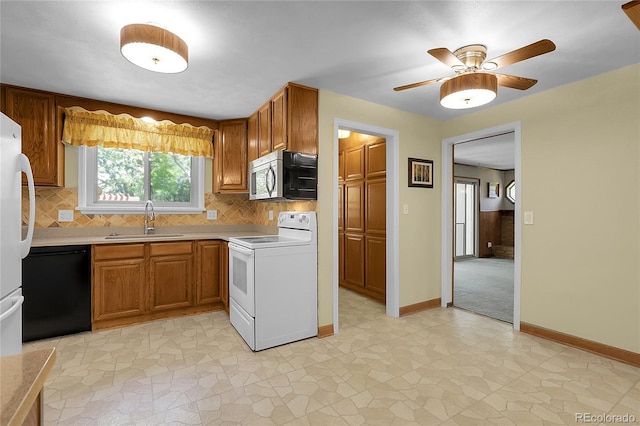 1091 E Pinewood Ave, Centennial, CO 80121 - kitchen featuring white appliances, light countertops, backsplash, and brown cabinets
