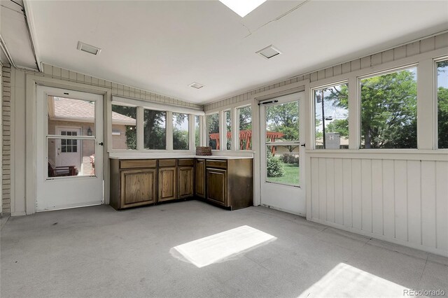 1091 E Pinewood Ave, Centennial, CO 80121 - unfurnished sunroom featuring plenty of natural light, lofted ceiling, and carpet
