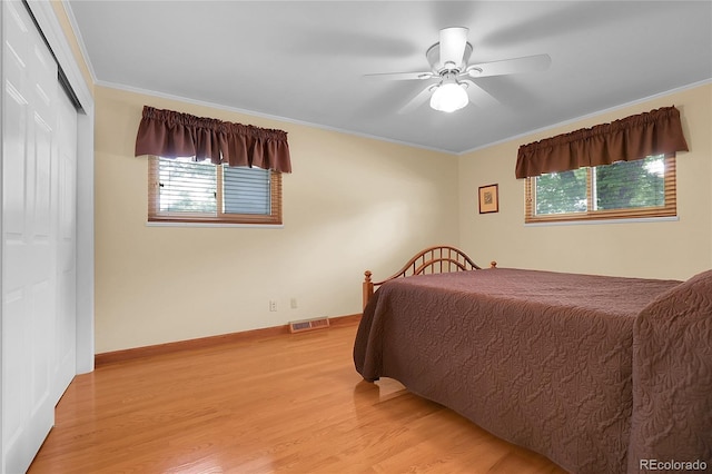 1091 E Pinewood Ave, Centennial, CO 80121 - bedroom featuring ornamental molding, light wood-type flooring, multiple windows, a closet, and ceiling fan
