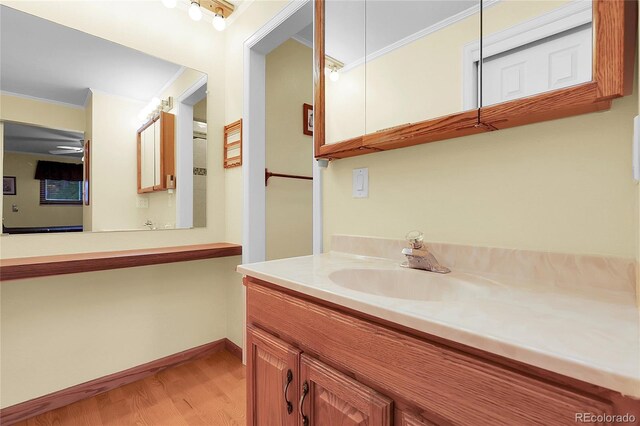 1091 E Pinewood Ave, Centennial, CO 80121 - bathroom with crown molding, wood finished floors, vanity, and ceiling fan