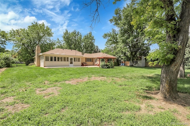 1091 E Pinewood Ave, Centennial, CO 80121 - rear view of house featuring a chimney, a patio, and a storage unit