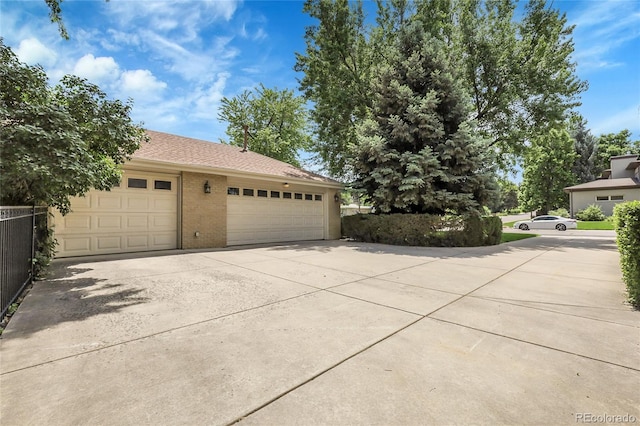 1091 E Pinewood Ave, Centennial, CO 80121 - view of home's exterior with concrete driveway, brick siding, and a garage