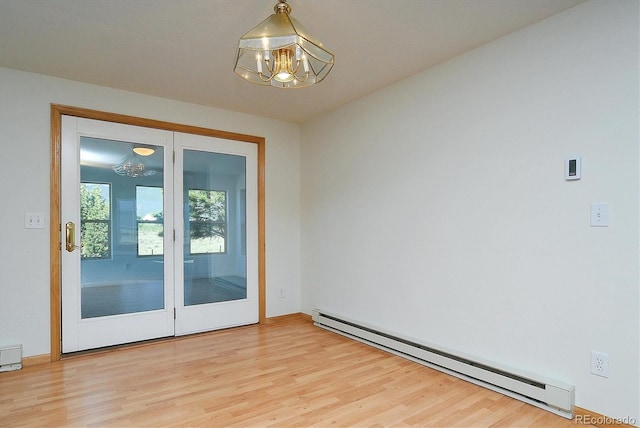 30870 County Road 356, Buena Vista, CO 81211 - spare room featuring a baseboard radiator, a chandelier, and wood finished floors