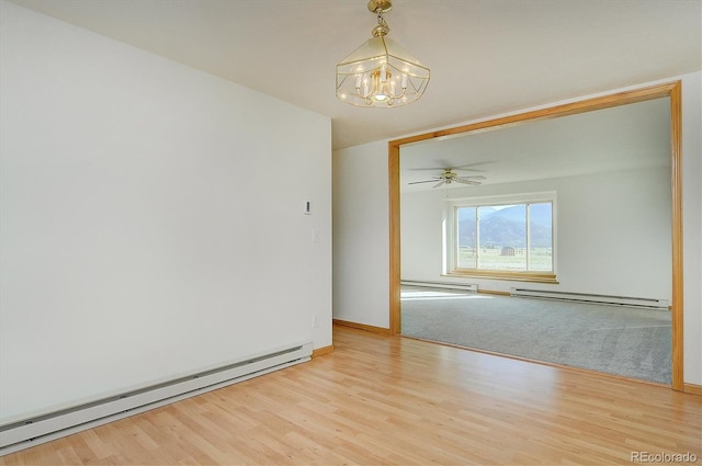 30870 County Road 356, Buena Vista, CO 81211 - spare room with a baseboard radiator, a chandelier, and light wood finished floors