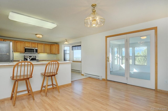 30870 County Road 356, Buena Vista, CO 81211 - kitchen featuring stainless steel appliances, healthy amount of natural light, a baseboard heating unit, and light wood-style flooring