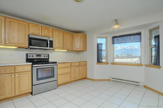 30870 County Road 356, Buena Vista, CO 81211 - kitchen featuring stainless steel appliances, a baseboard radiator, light brown cabinets, and light tile patterned floors