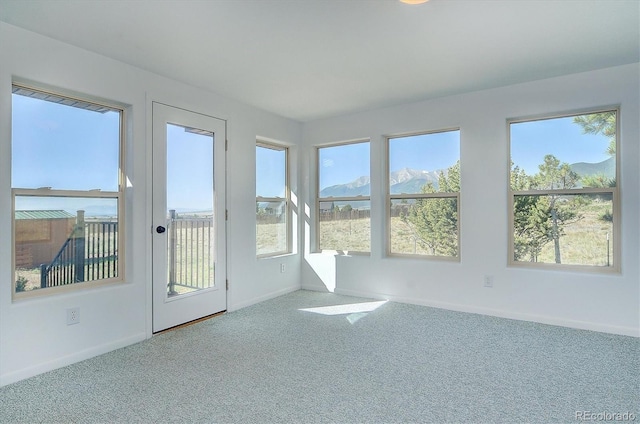 30870 County Road 356, Buena Vista, CO 81211 - unfurnished sunroom featuring carpet, plenty of natural light, and a mountain view