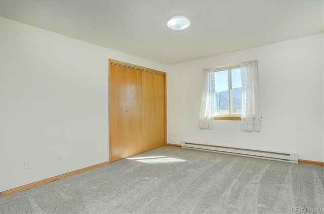 30870 County Road 356, Buena Vista, CO 81211 - unfurnished bedroom featuring a baseboard heating unit, carpet flooring, and a closet