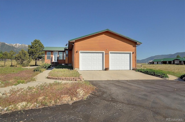 30870 County Road 356, Buena Vista, CO 81211 - view of front facade with a mountain view, driveway, and a garage