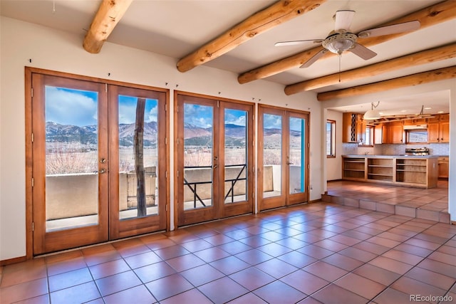 entryway featuring a ceiling fan, tile patterned flooring, french doors, and a mountain view