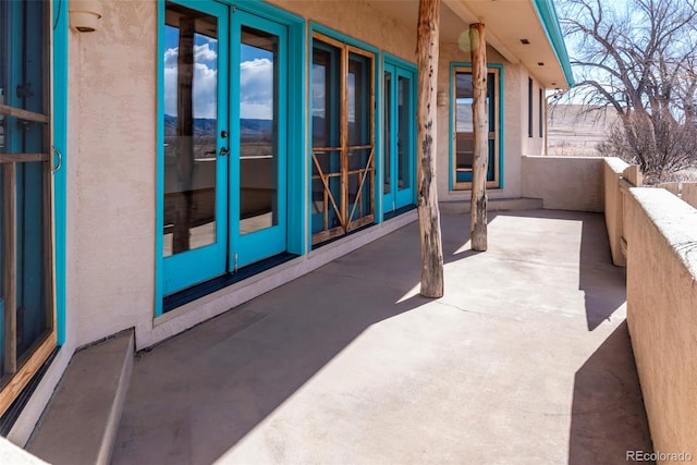 view of patio / terrace featuring a balcony and french doors