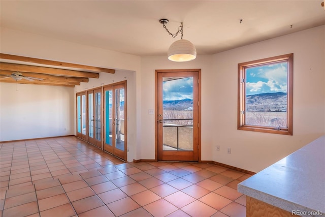 doorway featuring light tile patterned floors, ceiling fan, baseboards, french doors, and beam ceiling