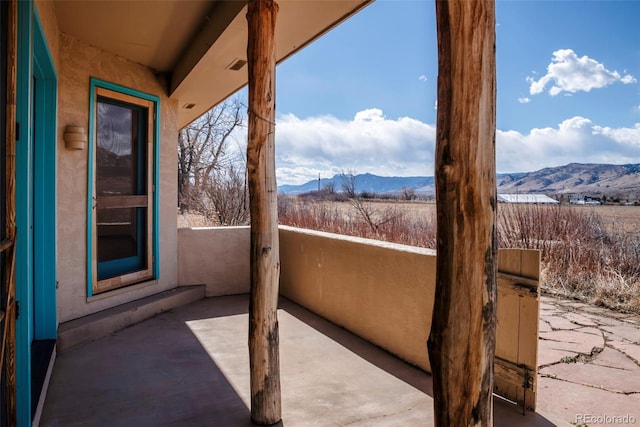 view of patio / terrace featuring a mountain view and a balcony