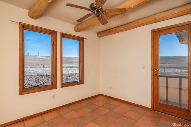 tiled empty room featuring a ceiling fan, baseboards, and beam ceiling