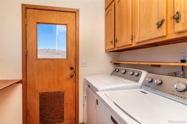 laundry area featuring washing machine and dryer and cabinet space