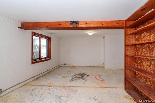 empty room with unfinished concrete flooring