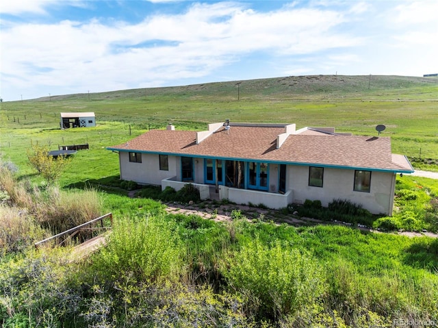 8602 N 39th St, Longmont, CO 80503 - rear view of house with a view of countryside, stucco siding, and roof with shingles