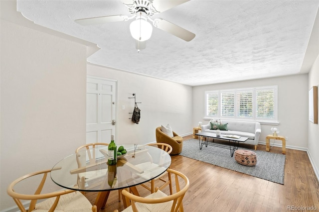 2047 S Milwaukee St Unit 4, Denver, CO 80210 - dining area featuring a ceiling fan, a textured ceiling, and wood finished floors