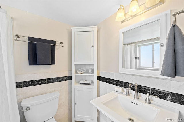 2047 S Milwaukee St Unit 4, Denver, CO 80210 - bathroom featuring a sink, tile walls, wainscoting, and toilet