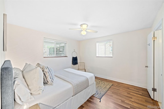 2047 S Milwaukee St Unit 4, Denver, CO 80210 - bedroom with baseboards, a ceiling fan, wood finished floors, and multiple windows