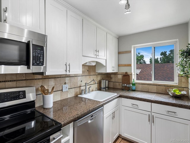 2047 S Milwaukee St Unit 4, Denver, CO 80210 - kitchen with appliances with stainless steel finishes, open shelves, white cabinetry, tile countertops, and tasteful backsplash