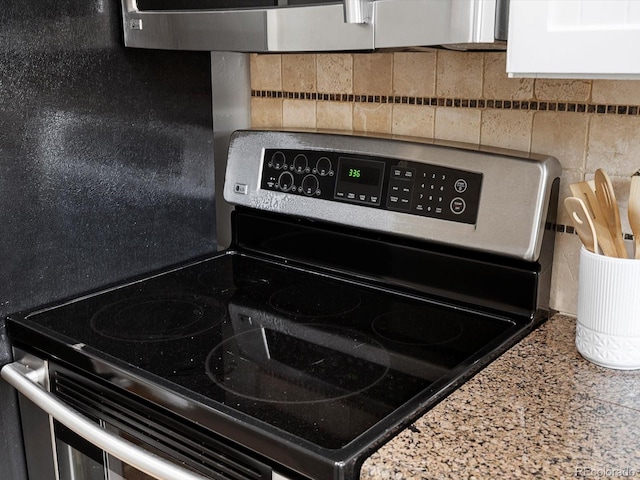2047 S Milwaukee St Unit 4, Denver, CO 80210 - kitchen view of stainless steel electric range and tasteful backsplash