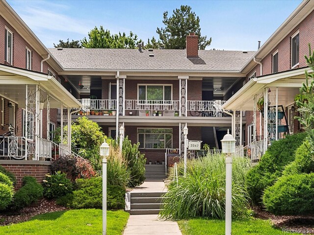 2047 S Milwaukee St Unit 4, Denver, CO 80210 - view of front of home with a chimney, stairs, and covered porch
