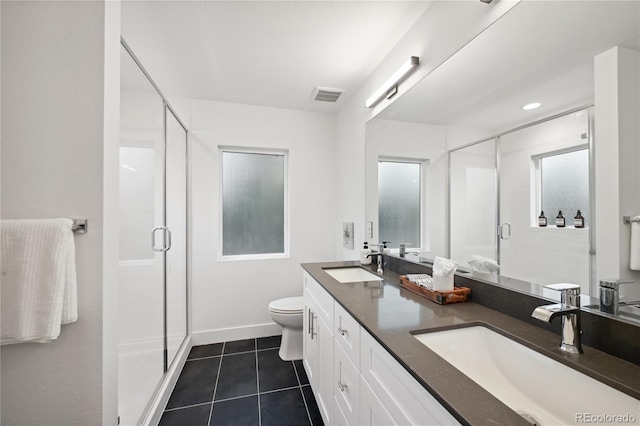 bathroom featuring toilet, walk in shower, vanity, and tile patterned flooring