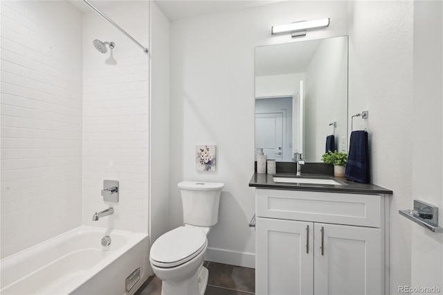 full bathroom featuring toilet, tiled shower / bath combo, and vanity