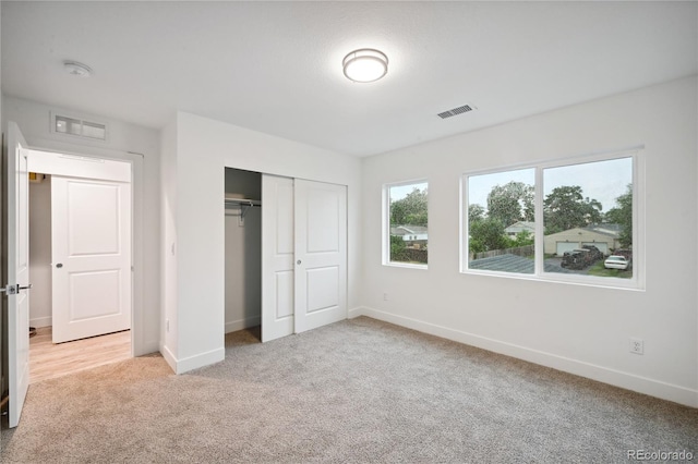 unfurnished bedroom featuring carpet and a closet