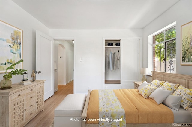 bedroom featuring light hardwood / wood-style flooring and a closet