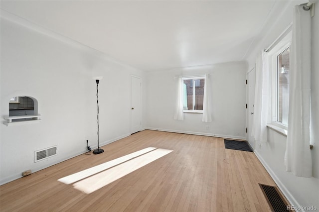 spare room with light hardwood / wood-style floors