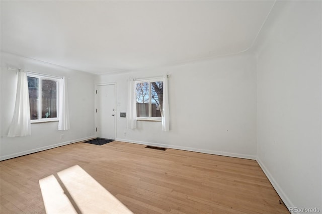 empty room with light hardwood / wood-style floors