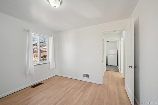 spare room featuring light wood-type flooring