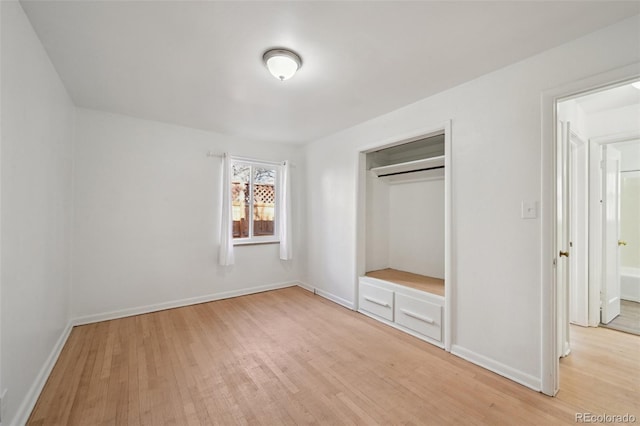 unfurnished bedroom featuring light hardwood / wood-style floors and a closet