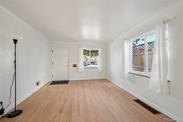 spare room with light wood-type flooring