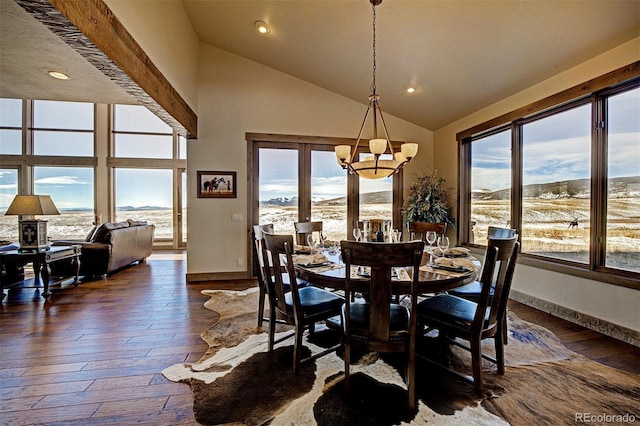 dining room with high vaulted ceiling, a wealth of natural light, dark hardwood / wood-style floors, and a notable chandelier