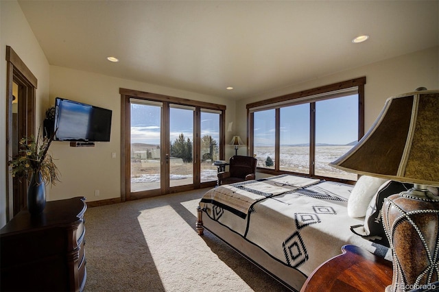 bedroom with a water view, access to exterior, french doors, and carpet flooring