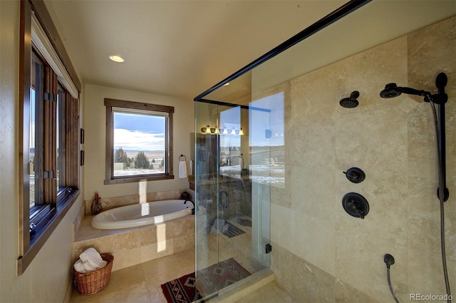 bathroom featuring independent shower and bath