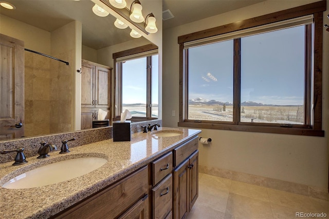 bathroom with plenty of natural light, vanity, and tile patterned flooring