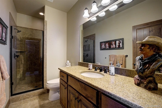 bathroom with toilet, a shower with shower door, and vanity