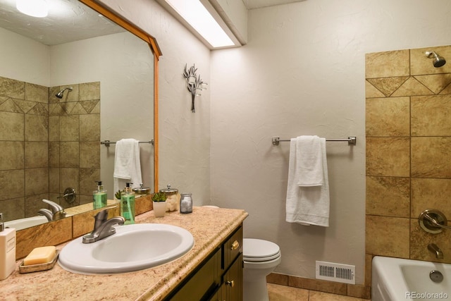 bathroom with vanity, visible vents, tile patterned flooring, shower / bathing tub combination, and toilet