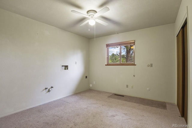 spare room with carpet flooring, visible vents, and ceiling fan