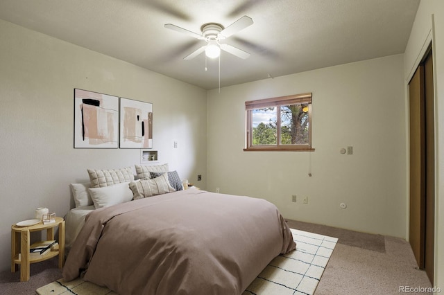 bedroom with light carpet, a closet, and ceiling fan